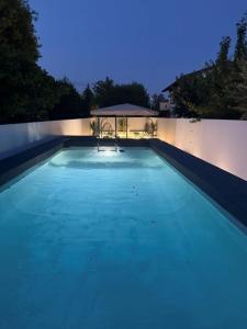 a large swimming pool at night with a gazebo at Rebecca's House in Staranzano
