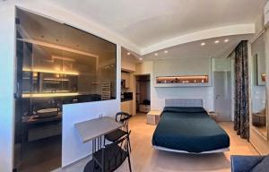 a living room with a bed and a kitchen at Tornola Luxury Rooms in Termoli