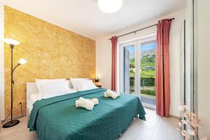 a bedroom with a bed with two stuffed animals on it at Villa Gold Residence 3 in Mlini +16 photos