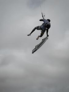 a man flying through the air on a pair of skis at Summer wave kudawa and Kite surfing school in Kalpitiya
