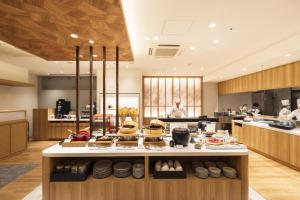 a kitchen with a counter with food on it at Richmond Hotel Sapporo Odori in Sapporo