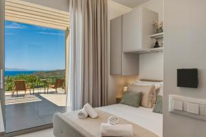 a bedroom with a bed and a view of the ocean at Villa Elliopetra - Adults Only in Vasilikí +45 photos