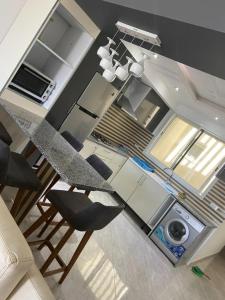 a kitchen with a counter and a table and chairs at kelibia in Kelibia