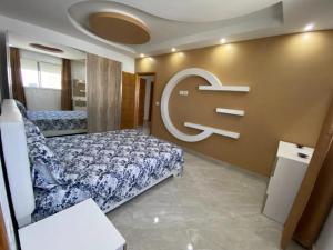 a bedroom with a bed and a sign on the wall at kelibia in Kelibia