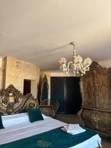 a bedroom with a large bed and a chandelier at Canada Castle in Eforie Nord