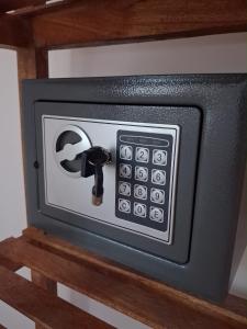 a microwave oven on a wooden shelf at Jambiani Kite Lodge in Jambiani