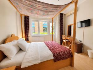 a bedroom with a large bed with a canopy at Marmara Guesthouse in Istanbul
