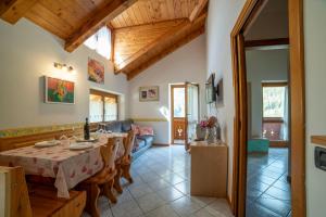 a dining room with a table and a couch at Casa Bamby in Cogolo