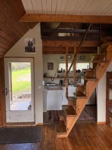 a room with a staircase in a house at Eha Farmstay in Rõuge