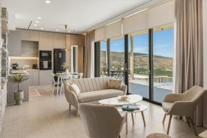 a living room with a couch and a table at Villa Elliopetra - Adults Only in Vasilikí