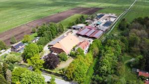 an aerial view of a house with a farm at Biohof Holthusen in Hammelwarder Außendeich