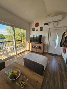 a living room with a bed and a large window at Holiday home Ramovic in Virpazar