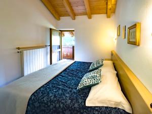 a bedroom with a bed with pillows on it at Casa Bamby in Cogolo