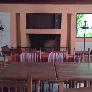 a classroom with wooden tables and chairs and a blackboard at Posada Kalku in El Tabo