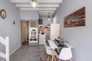 a kitchen with white appliances and a table and chairs at Bursa Cottage House in Mesochórion