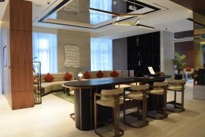 a dining room with a large table and chairs at Carlton Downtown Hotel in Dubai +76 photos