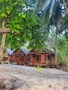 a wooden house in the middle of a forest at Kemmi Homestay Raja Ampat in Merpati +14 photos