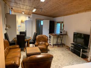 a living room with leather furniture and a flat screen tv at Very Attractive Location in Täby