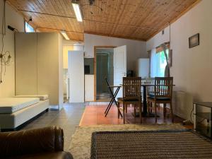 a living room with a couch and a table and chairs at Very Attractive Location in Täby +3 photos
