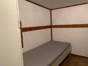 a small room with a bed in the wall at Very Attractive Location in Täby