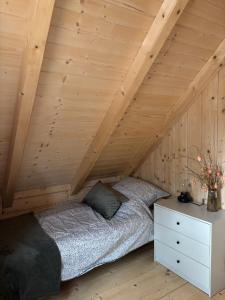 a bedroom with a bed in a attic at Chata u Drwala Święta Lipka in Święta Lipka