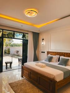 a bedroom with two beds and a large window at Serian Breeze 6 Bedroom Villa Diani in Ukunda +27 photos
