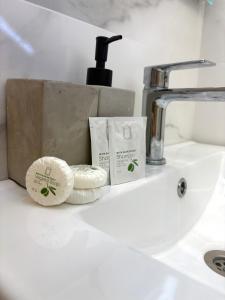 a bathroom sink with a faucet and two towels at Urban Apart in Stara Zagora +7 photos