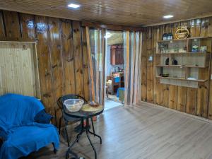 a room with wooden walls and a table in a room at Iamze's Guest House in Mestia