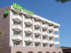 a building with a big sign on top of it at ibis Styles Fréjus St Raphael in Fréjus
