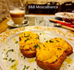 a plate of food with a piece of bread with cheese at B&B Mosca Bianca in Ascoli Piceno +27 photos
