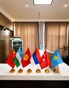 a table topped with colorful flags on display at All residence in Almaty
