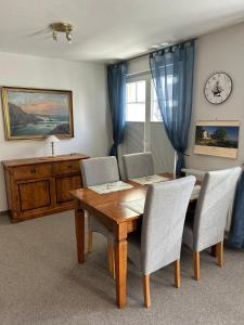 a dining room with a wooden table and chairs at Ferienwohnung-Silvie-8 in Westerland