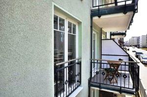 a balcony of a building with a table on it at Ferienwohnung-Silvie-8 in Westerland