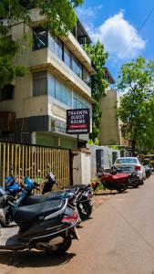 a row of scooters parked in front of a building at Thaanya Guest Rooms in Chinchwad +25 photos