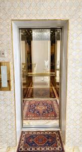a glass door leading into a room with a rug at West inn Luxury Baku in Baku
