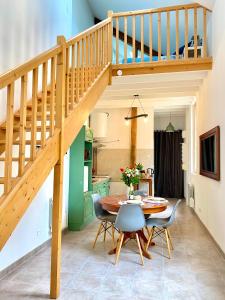 a dining room with a table and a staircase at Le secret du Morvan in Saulieu +28 photos