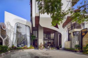 a rendering of a building with a tree at Chaiya Palace Hotel in Phnom Penh