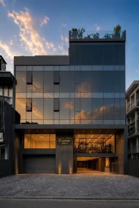 a large glass building with a sunset in the background at TS Apartment in Hanoi