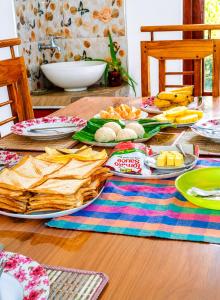 a wooden table with plates of food on it at Silver Tips Villa in Ella +17 photos