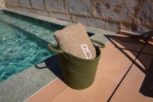 a basket with the letter b on it sitting next to a pool at Bytra Boutique Hotel - Adults Only in Petra