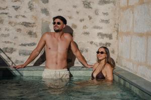 a man and a woman standing in a swimming pool at Bytra Boutique Hotel - Adults Only in Petra +14 photos