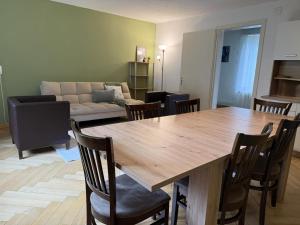 a living room with a large wooden table and chairs at Revier schlicht und bahnsinnig in Mitlödi +13 photos
