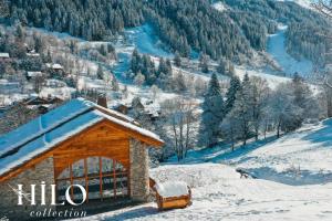 a small building in the snow with a truck at Chalet Alya by HILO Collection in Les Allues +31 photos