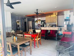a kitchen and dining room with tables and chairs at The Nice Patong Hotel in Patong Beach