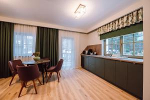 a kitchen and dining room with a table and chairs at Vila Bernady Sovata in Sovata