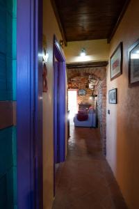 a hallway with a hallway leading to a room with a bed at NIDO SCANSANESE in Scansano