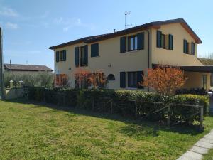 a house with a fence in front of it at La Valle in Villa Verucchio