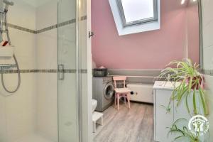 a bathroom with a shower and a washing machine at De l'ar mor bihan in Riantec +28 photos