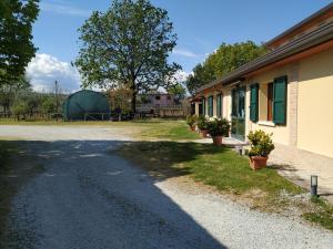 a road next to a building with potted plants at La Valle in Villa Verucchio
