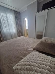 a bedroom with a large bed with a large mirror at Sky Nest Batumi in Batumi